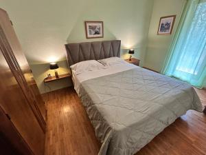 a bedroom with a large bed and two night stands at Villa Kate in Vis