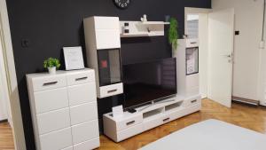 a large white entertainment center with a flat screen tv at Lela's home II in Knjazevac.
