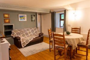 a living room with a table and a couch at Moore's Cottage in Birr