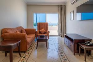 a living room with a couch and a chair at Radwa Ramada Resort in Yanbu