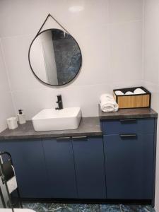 a bathroom with a sink and a mirror at VeloDomki Żywiec - domki nad Jeziorem Żywieckim in Żywiec +92 photos