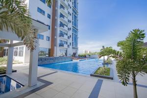 a swimming pool in the middle of a building at The Mactan Beach Haus in Punta Engaño