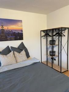 a bedroom with a bed with a picture on the wall at Apartment in Marburg in Marburg an der Lahn