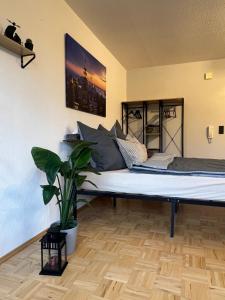 a large bed in a room with a potted plant at Apartment in Marburg in Marburg an der Lahn