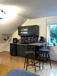 a kitchen with a counter and two bar stools at Apartment in Marburg in Marburg an der Lahn