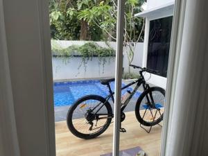 a bike parked in a room with a window at D'illy Borobudur Villa in Magelang