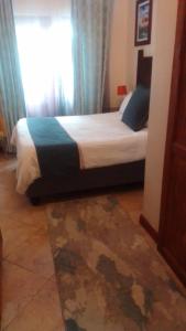 Ένα ή περισσότερα κρεβάτια σε δωμάτιο στο Christland Guest House