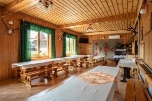 a large room with tables and benches in it at U Chowańca in Murzasichle