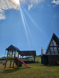 a playground with a slide and a play structure at Under Sky House - Vikendica - Manjača in Banja Luka