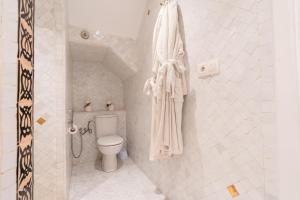 a white bathroom with a toilet and a shower at Kasbah Dream - Great Location in Tangier in Tangier +42 photos