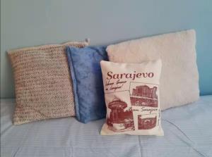 a bag of saranwrap sitting on a bed with pillows at Comfy Room With Working Space in top Location in Ivišovo Greblje