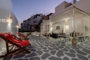 a patio with a red chair on top of a building at Kasbah Dream - Great Location in Tangier in Tangier