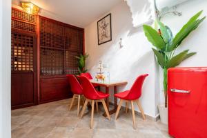 a red dining room with a table and red chairs at Kasbah Dream - Great Location in Tangier in Tangier