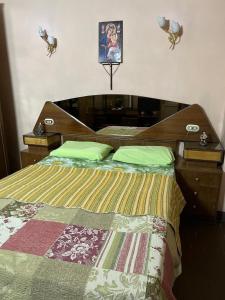 a bedroom with a bed with a wooden head board at Velvet Rose Apartment in Luxor +16 photos
