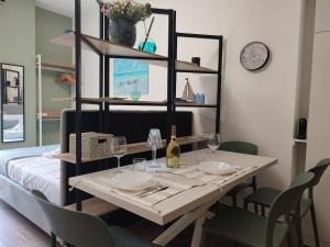 a dining room table with plates and wine glasses at Magic Home in Ceriale
