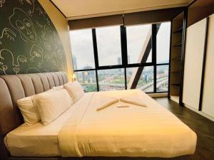a large bed in a room with a large window at Scarletz klcc by R&R in Kuala Lumpur +34 photos