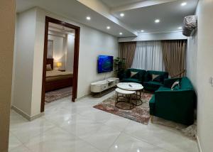 a living room with a couch and a table at Premium Pavilion in Islamabad