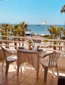 a table and chairs on a balcony with a view of the ocean at Sea view in Juan Les Pins in Juan-les-Pins