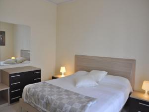 a bedroom with a large white bed with two night stands at Holiday Home in Lazise near Lake Garda in Lazise
