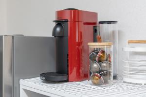 a red coffee maker sitting on top of a refrigerator at Cozy Stay in Seoul