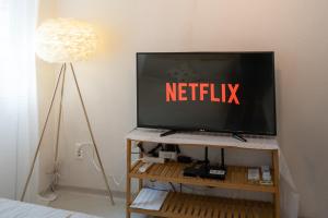 a television with the words netflix on the screen at Cozy Stay in Seoul
