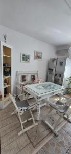 a white table and chairs in a room at Vintage Central Apartament in Târgu Jiu +30 photos