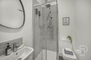 a bathroom with a shower and a sink at Luxe Ami Beh Large Group Apartment by PolkaStays in Blackpool