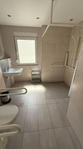 a bathroom with a toilet and a sink and a window at Casa Emilio in Haßloch +2 photos