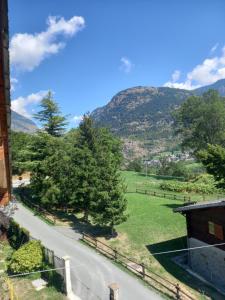 a view of a road with a mountain in the background at Maison du bois in Torgnon
