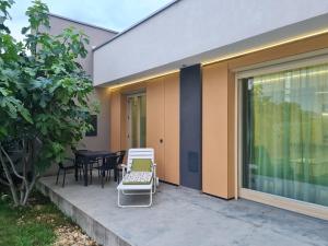 a house with a patio with a table and chairs at Füge-lak in Hajdúszoboszló +7 photos
