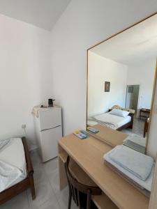 a room with a mirror and a table and a bed at Dina House in Himare