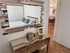 a mirror on a wall with a bed in a room at Azur by Gergana in Bŭnzareto