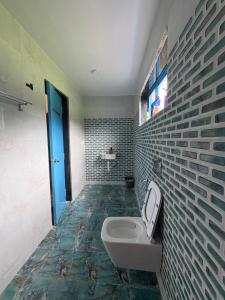 a bathroom with a sink and a toilet in it at Aweka Villa - 3 BHK Riverside - Karjat in Dhamni