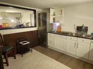 a kitchen with a sink and a refrigerator at Close to Karmøy and Haugesund airport in Karmøy