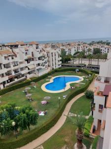 arial view of a resort with a swimming pool and buildings at Apartamento playas de Vera in Vera