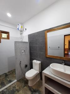 a bathroom with a toilet and a sink and a mirror at All View Resort in Tangalle +75 photos