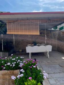 a patio with a swing and some flowers at A Casa do Abuelo in Ourense