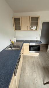 an empty kitchen with a sink and a stove at Casa Emilio in Rüsselsheim +5 photos