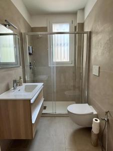 a bathroom with a shower and a toilet and a sink at Villa Vittoria Apartments in Venice-Lido +6 photos