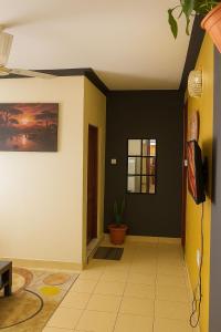 a hallway with black walls and a plant at Delta shop house in Mombasa