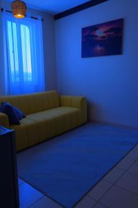 a living room with a couch in a blue room at Delta shop house in Mombasa
