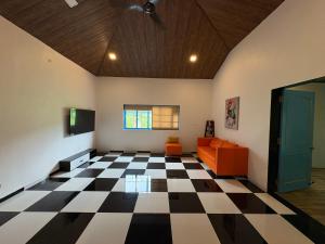 a living room with a black and white checkered floor at Aweka Villa - 3 BHK Riverside - Karjat in Dhamni