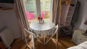 a room with a table and a window with pink chairs at Exmoor retreat on Two Moors Way in Withypool