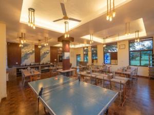a large dining room with tables and chairs and a large ping at Eiyuu Hotels - Wildlife & Nature Vista in Jhirna