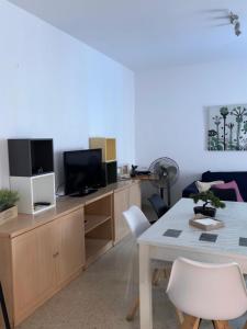 a living room with a table and a tv at Sevilla. Gerena Casa Rural para familia o profesionales in Gerena +32 photos