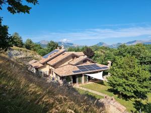 a house with solar panels on top of a hill at BnB Bagno di Bosco in Gubbio