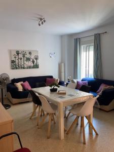 a living room with a table and chairs at Sevilla. Gerena Casa Rural para familia o profesionales in Gerena
