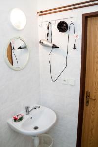 a white bathroom with a sink and a mirror at Turisticka ubytovna Cakle in Ústí nad Orlicí