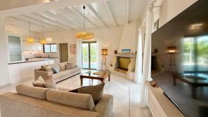 a living room with two couches and a table at Elysian Retreat in Messini