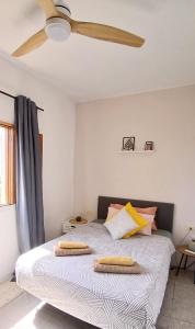 a bedroom with a bed with a ceiling fan at La Casita de Puerto in Puerto del Rosario